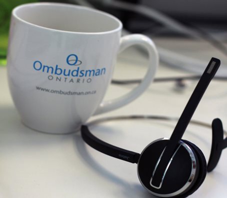 telephone headset and mug with the logo of the Ontario Ombudsman