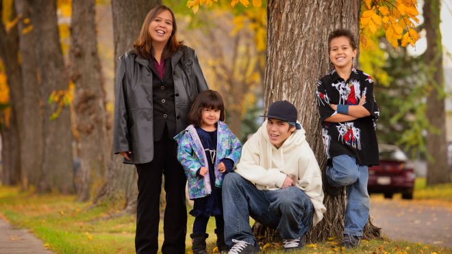 Family of four outside in a park