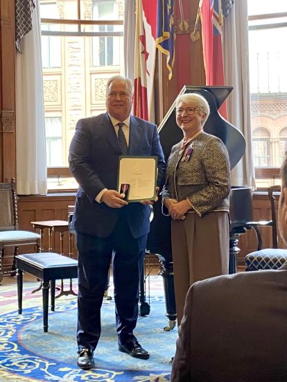 Ontario's Ombudsman Paul Dubé being presented the King Charles III Coronation Medal by Lieutenant Governor Édith Dumont. 