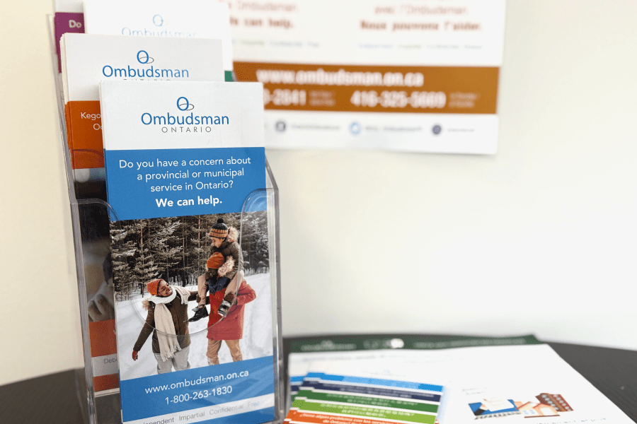 On a table, various Ombudsman Ontario brochures and handouts.