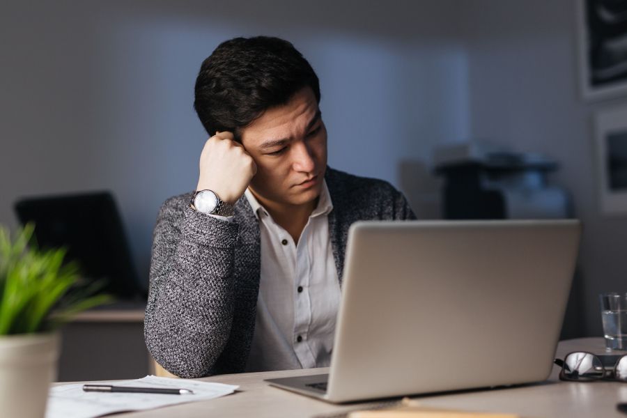  Man sitting in front of laptop at office