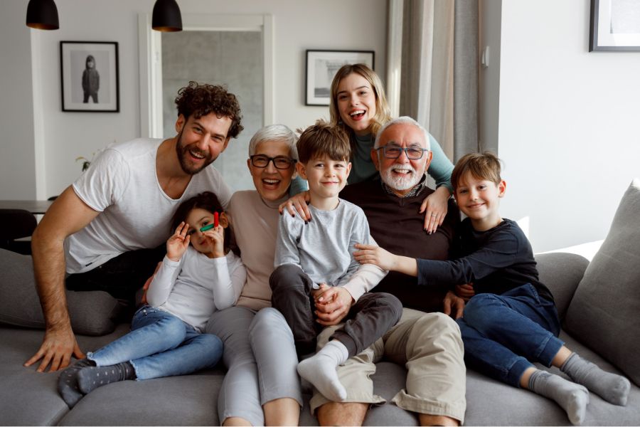 A multi-generational family sitting on a couch