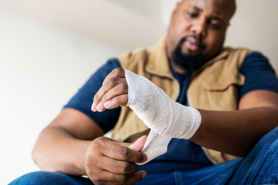 Person bandaging an injured hand