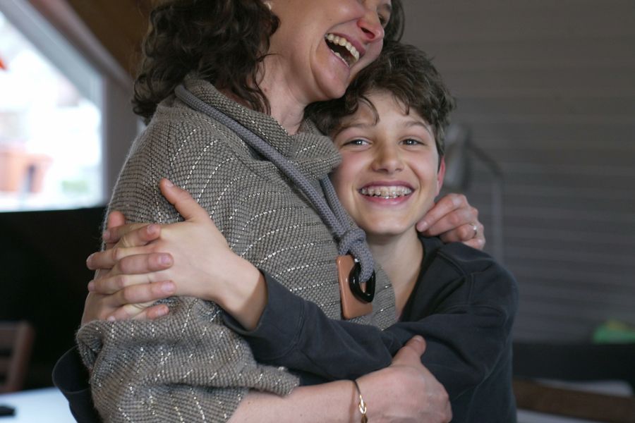 An adult hugging a child